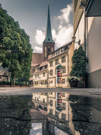 Reflection of buildings in puddle