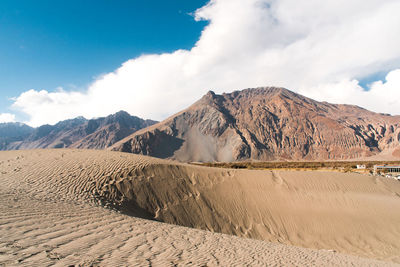 Scenic view of arid landscape against sky