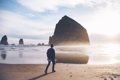 Full length of man walking at beach against sky