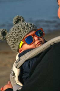 Portrait of boy wearing sunglasses on sea shore