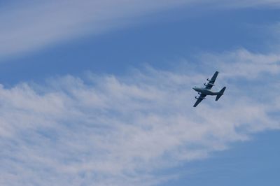 Aircraft flying against background of autumn blue sky