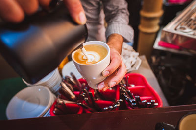 Close-up of barista making coffee in cafe