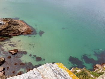 High angle view of rocks by sea