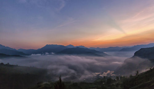 View of mountain range against cloudy sky