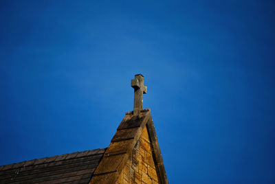 Low angle view of old building against clear blue sky