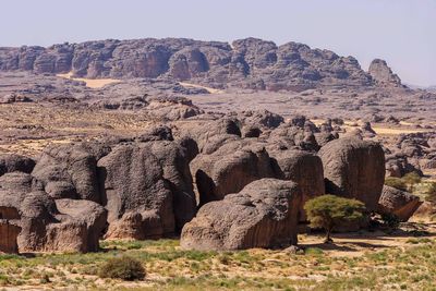 Rock formations on landscape against sky