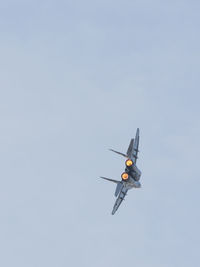 Low angle view of airplane flying against clear sky