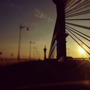 Silhouette of suspension bridge during sunset