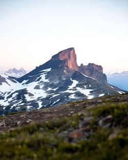 Scenic view of snowcapped mountains against clear sky