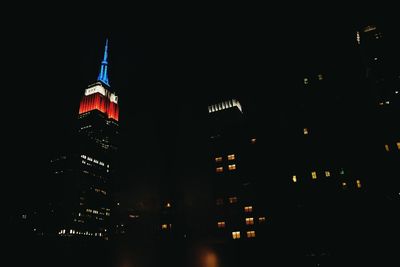 Low angle view of illuminated building against sky at night