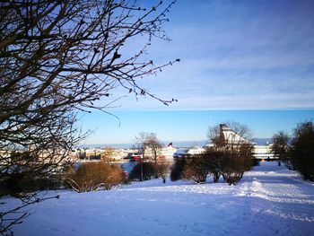 Snow covered land against sky