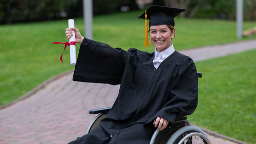 Portrait of woman wearing graduation gown