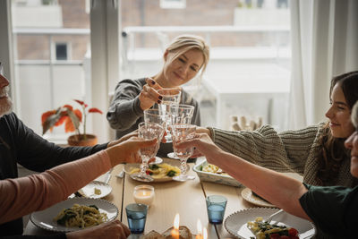 Family raising toast at dinner