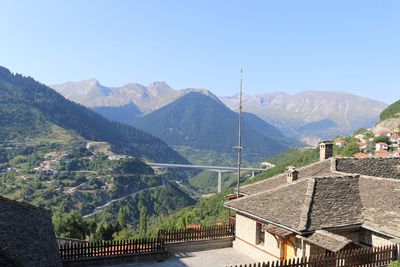 High angle view of townscape and mountains against clear sky