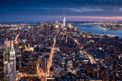 Aerial view of city lit up at night