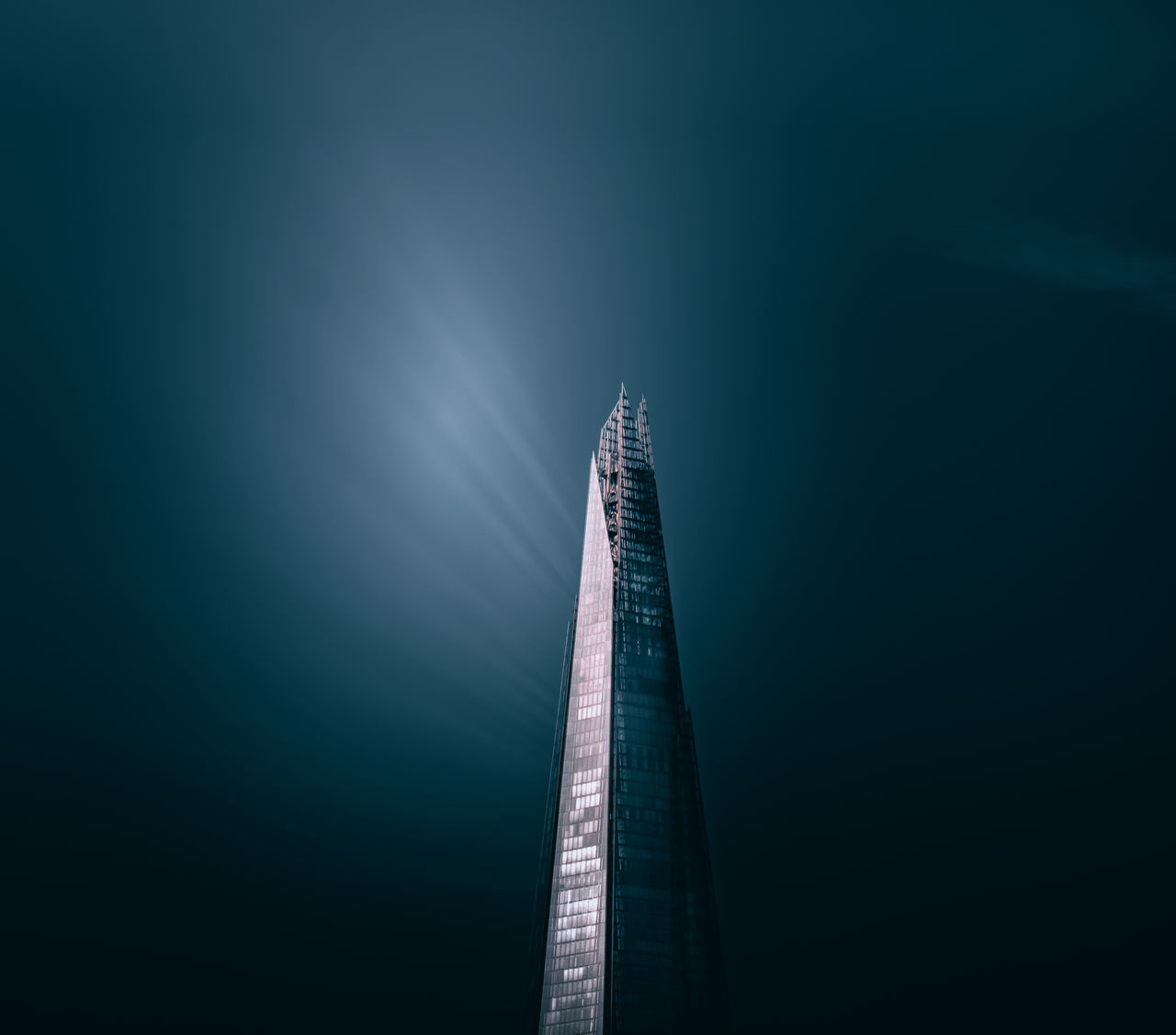 LOW ANGLE VIEW OF MODERN BUILDING AT NIGHT