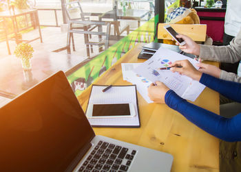 High angle view of woman using laptop on table