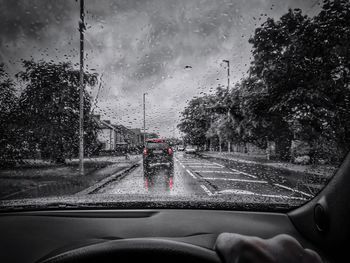 Road seen through wet windshield of car