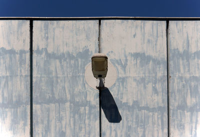 Close-up of electric lamp hanging on wall