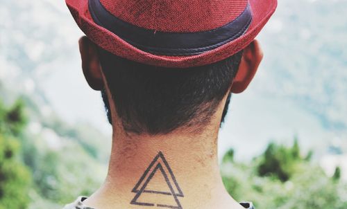 Rear view of man with tattoo on neck