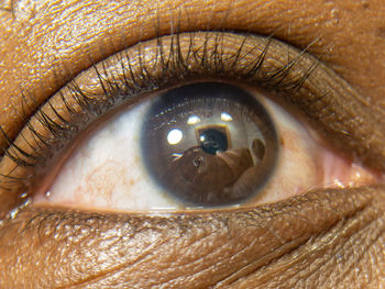 Close up of african american man dark brown eyes for use in ophthalmology optometry imagery