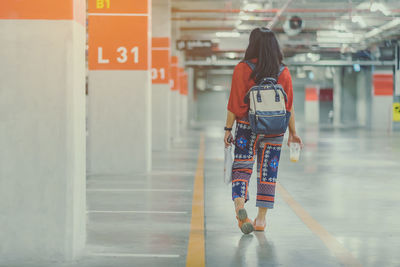 Rear view of woman walking in building