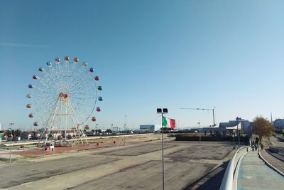 Ferris wheel against clear blue sky