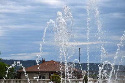 Close-up of water splashing against sky