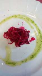 Close-up of red flower in plate