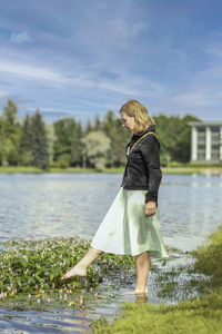 Rear view of woman standing in water