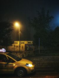 View of illuminated road at night