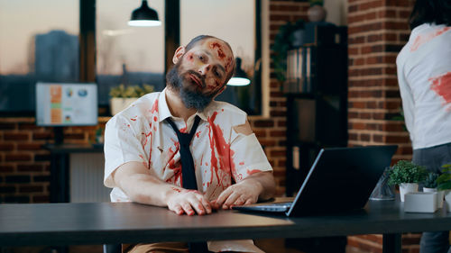 Young man using laptop at table