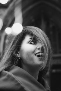 Close up excited young woman in festive city monochrome portrait picture