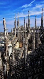 View of cityscape against cloudy sky