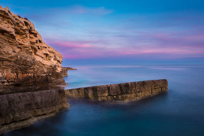 Scenic view of sea against cloudy sky