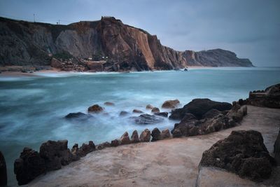 Scenic view of sea and mountains against sky