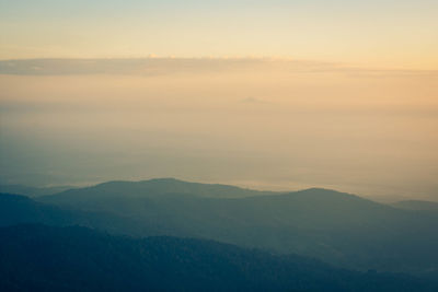 Scenic view of mountains against sky at sunset