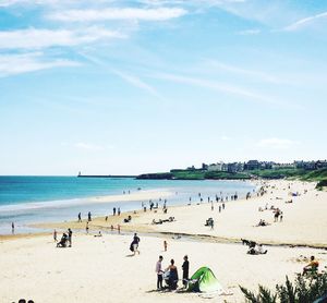 People on beach against sky