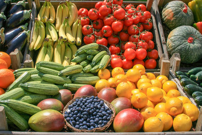 Beautiful composition of various fresh and ripe biological vegetables and fruits in wooden boxes