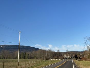 Country road against sky