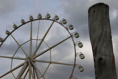 Low angle view of ferris wheel against sky