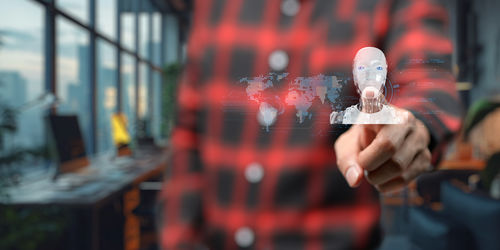 Midsection of woman holding illuminated light bulb