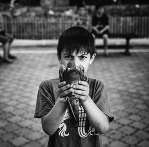 Portrait of boy holding camera