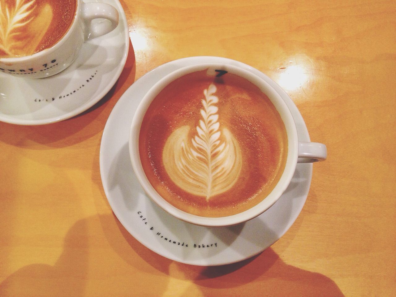 drink, coffee cup, food and drink, refreshment, coffee - drink, saucer, indoors, freshness, frothy drink, coffee, table, cappuccino, cup, froth art, still life, high angle view, close-up, beverage, directly above, spoon