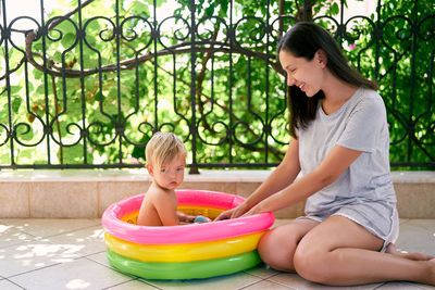 Mother and daughter playing at swimming pool