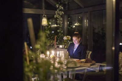 Rear view of woman sitting at restaurant