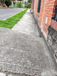 Empty road by buildings in city