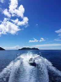 Boat sailing in sea against sky