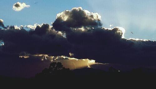 Scenic view of mountains against cloudy sky