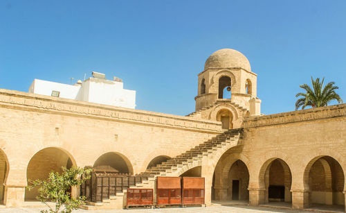 Low angle view of historical building against clear blue sky